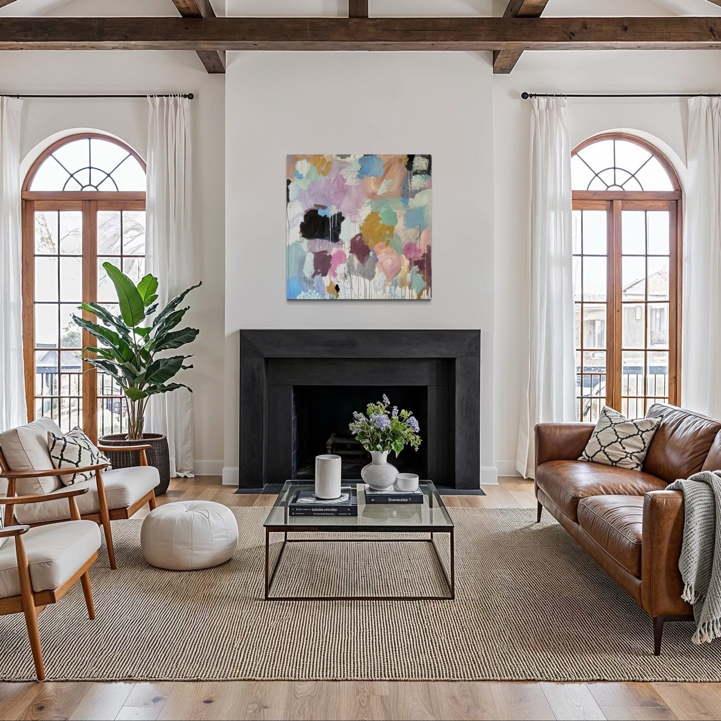 Living room with wooden beams, large windows, and modern decor.
