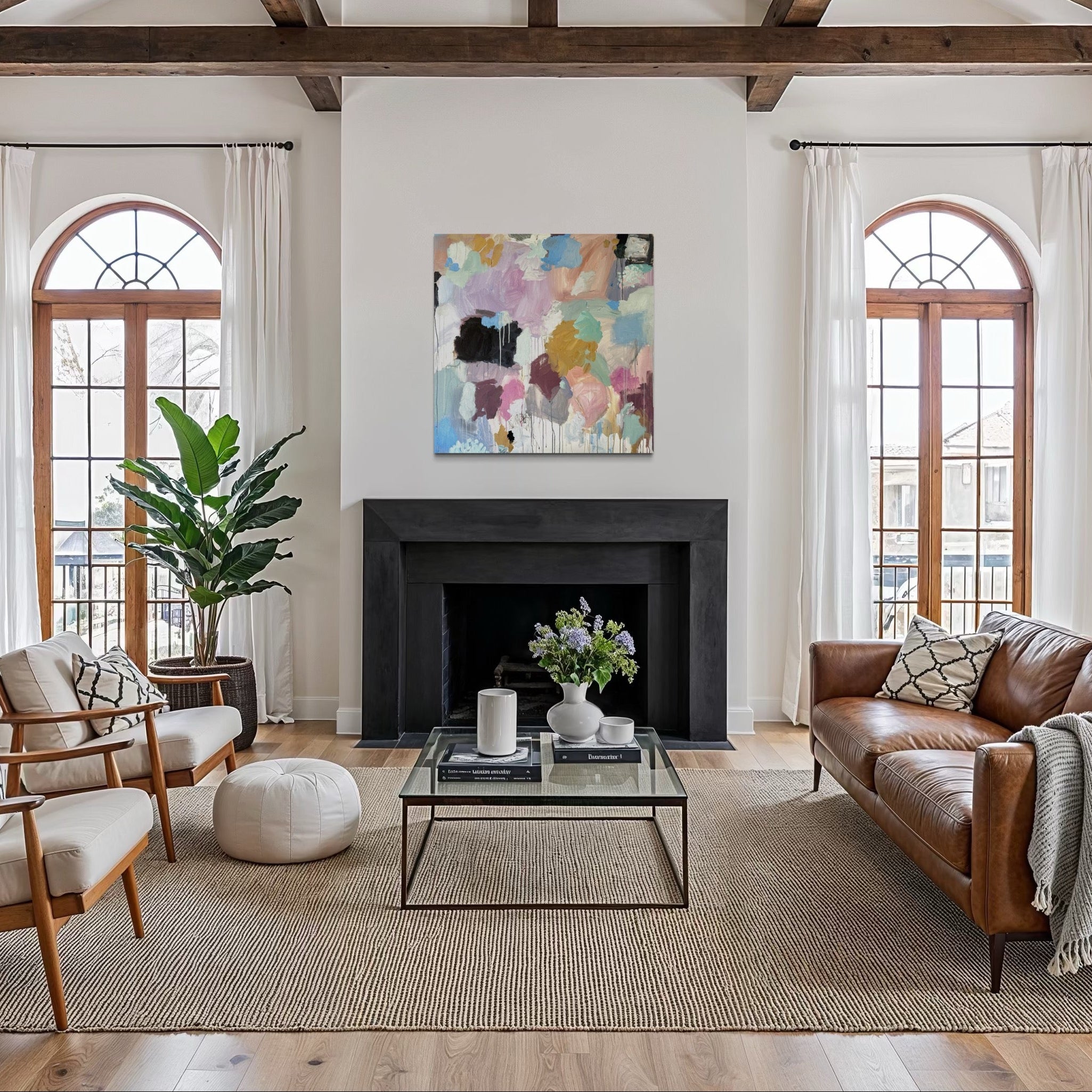 Living room with wooden beams, large windows, and modern decor.
